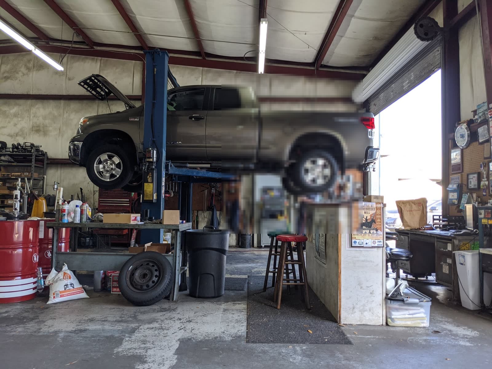 Pickup truck on a lift inside the shop